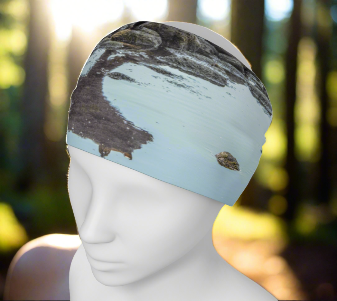 Headband and or neck gaiter with a image of a bear and its reflection as it crosses a creekbed.