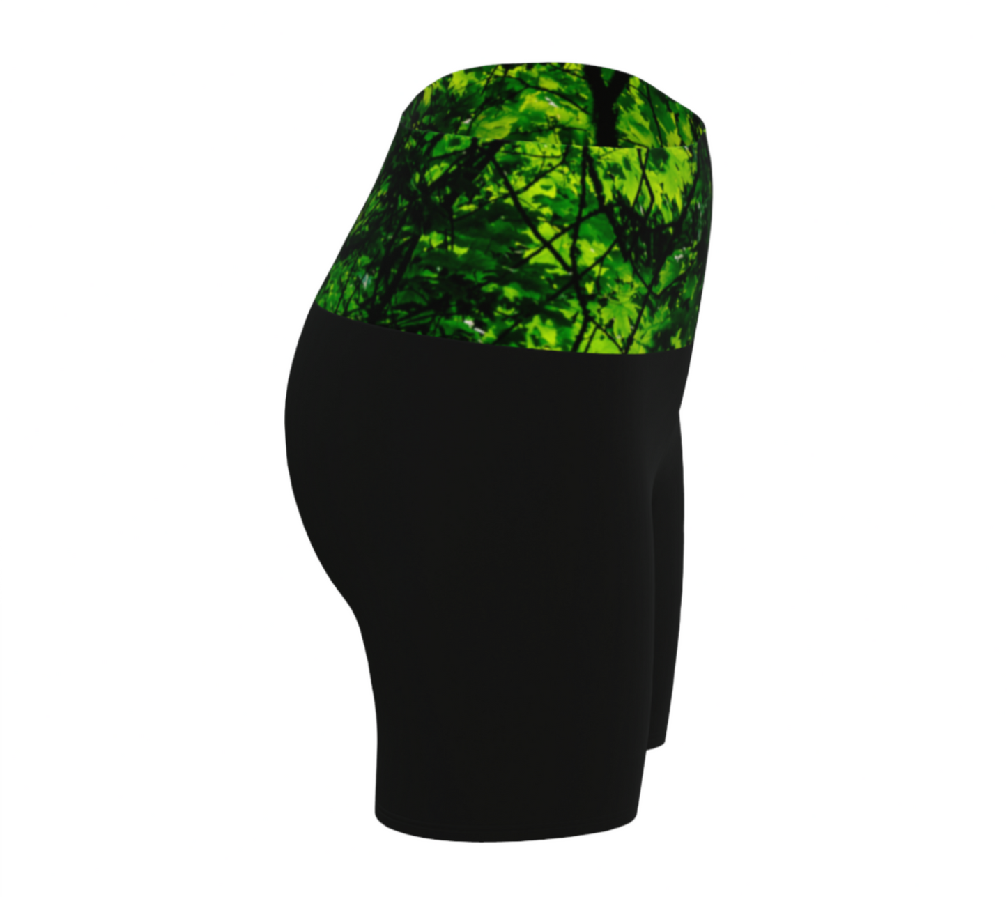 Side View Canopy of Leaves yoga shorts.  The high waist band features a canopy of leaves printed on it.  the bottom portion of the shorts are black.