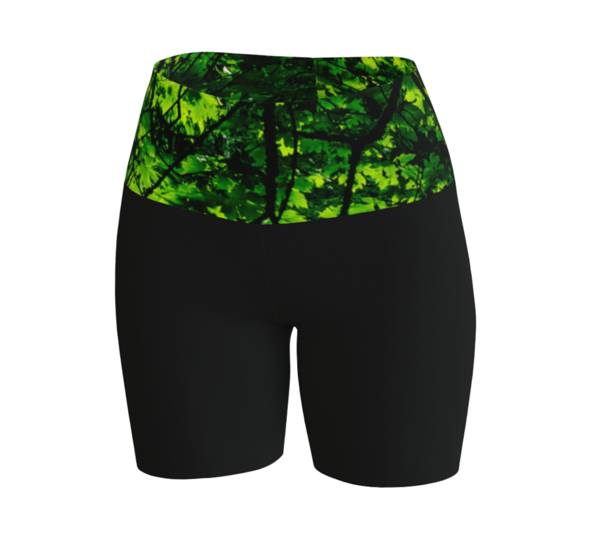 Canopy of Leaves yoga shorts.  The high waist band features a canopy of leaves printed on it.  the bottom portion of the shorts are black.