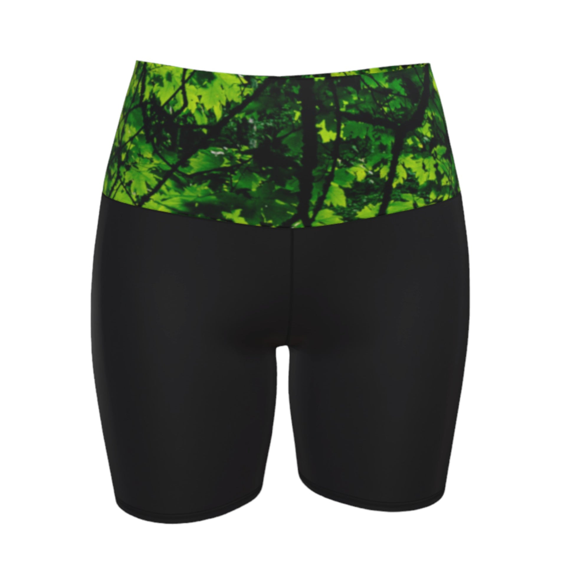 Canopy of Leaves yoga shorts.  The high waist band features a canopy of leaves printed on it.  the bottom portion of the shorts are black.