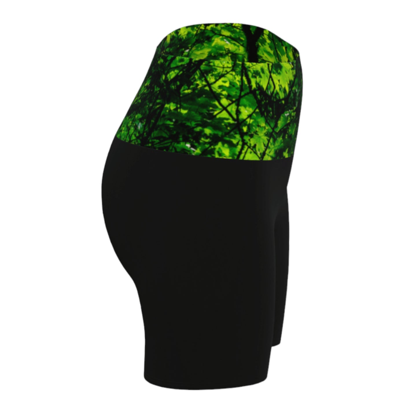 Canopy of Leaves yoga shorts.  The high waist band features a canopy of leaves printed on it.  the bottom portion of the shorts are black.