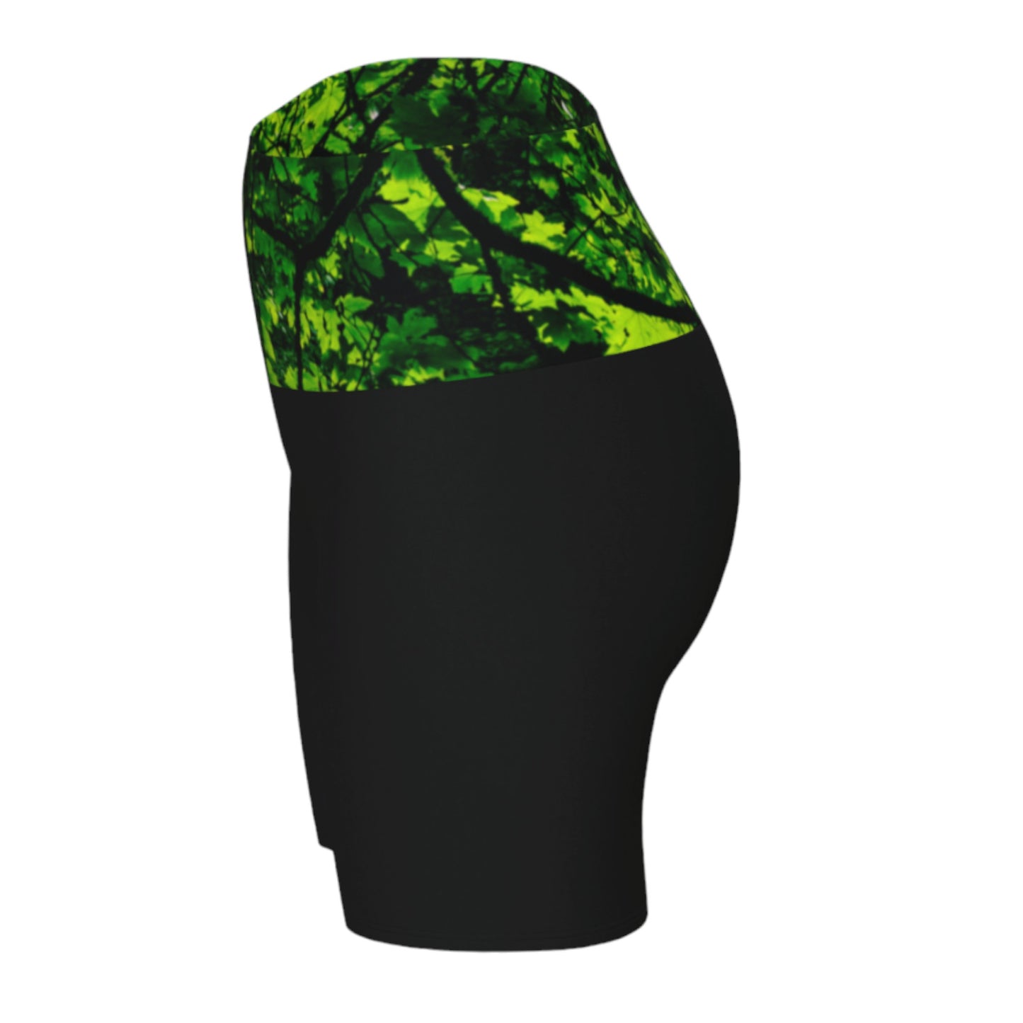 Canopy of Leaves yoga shorts.  The high waist band features a canopy of leaves printed on it.  the bottom portion of the shorts are black.