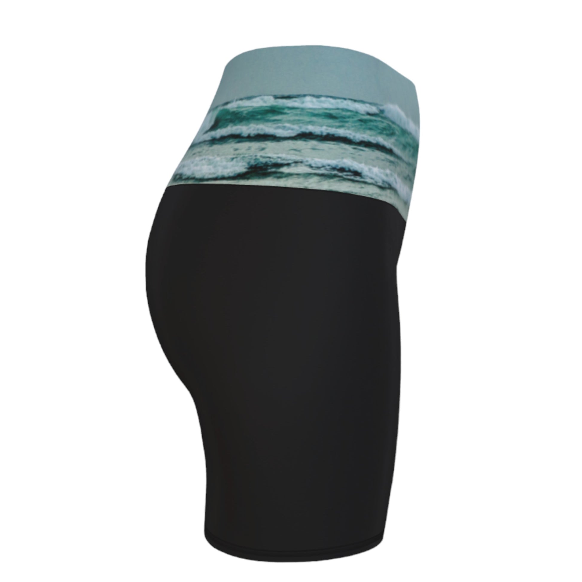 Ocean Calling Long Beach Tofino Yoga shorts.  The image of the ocean waves is printed on the waistband. The rest of the shorts is black.