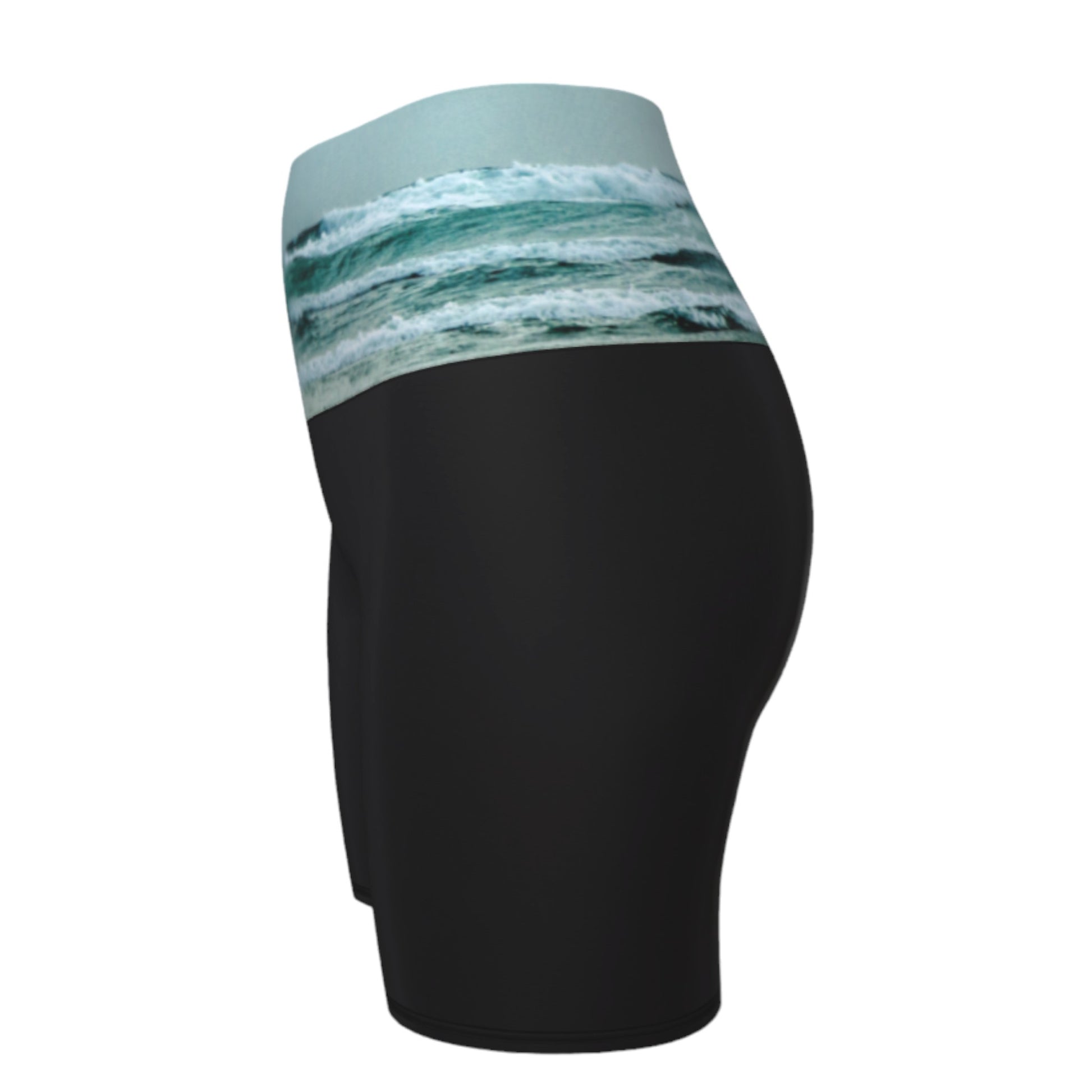 Ocean Calling Long Beach Tofino Yoga shorts.  The image of the ocean waves is printed on the waistband. The rest of the shorts is black.