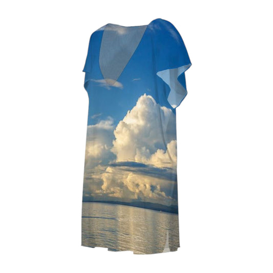 All over print dress with a image of beach ocean and big clouds.