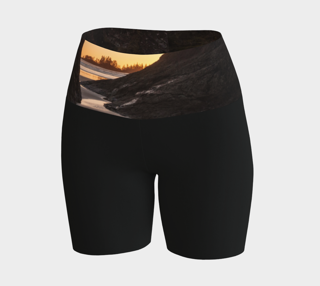Tofino Sunset Yoga Shorts features an image of a sunset at long beach tofino printed on the waistband. the rest of the shorts are black.