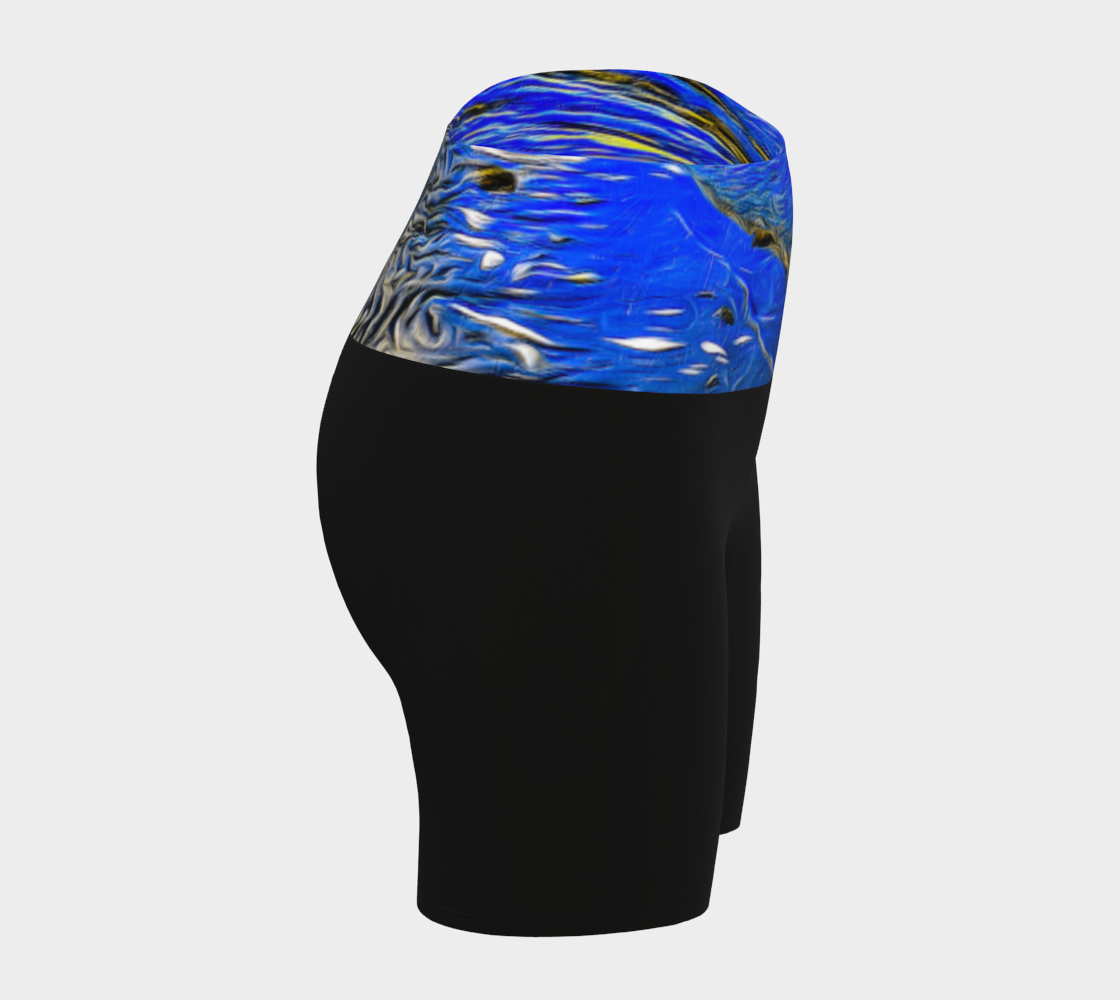 Ebb and Flow Yoga shorts feature a image of the ocean water at low tide with the sky and the sun reflecting on the water. This image is printed on the band of the yoga shorts.  The bottom of the shorts are black.