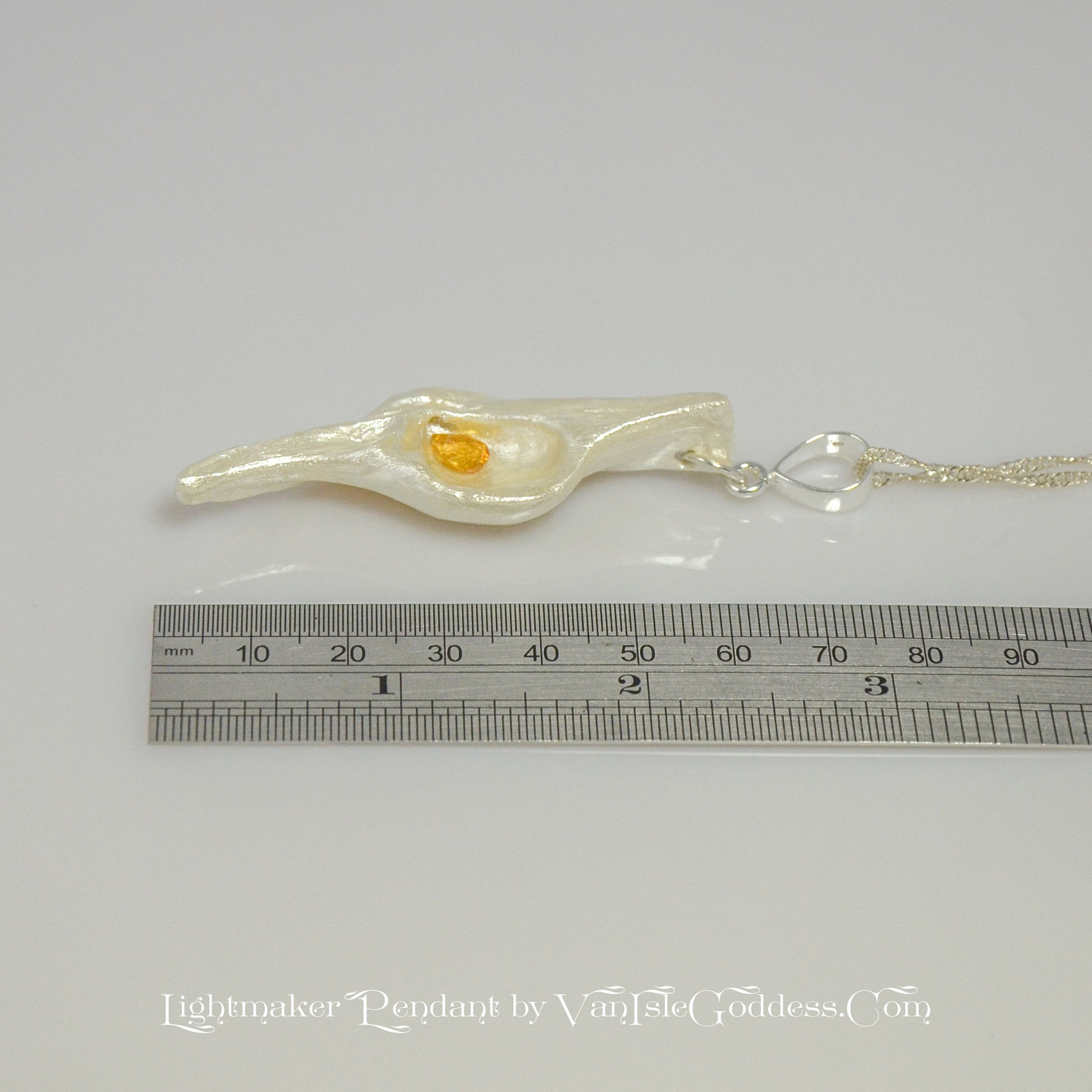 Lightmaker natural seashell pendant A beautiful pear shaped rose cut Citrine compliments the pendant. The pendant is shown along side a ruler so the viewer can see the length of the pendant.