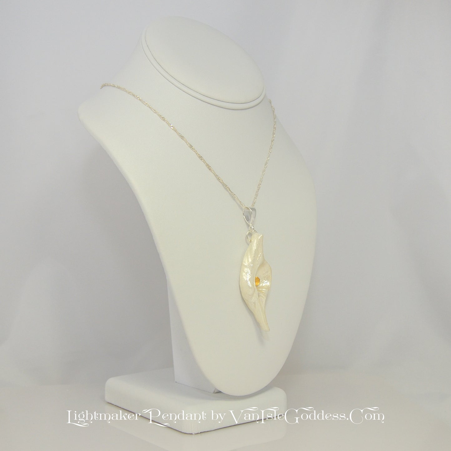 Lightmaker natural seashell pendant A beautiful pear shaped rose cut Citrine compliments the pendant. The pendant is turned to show the right side of the pendant.