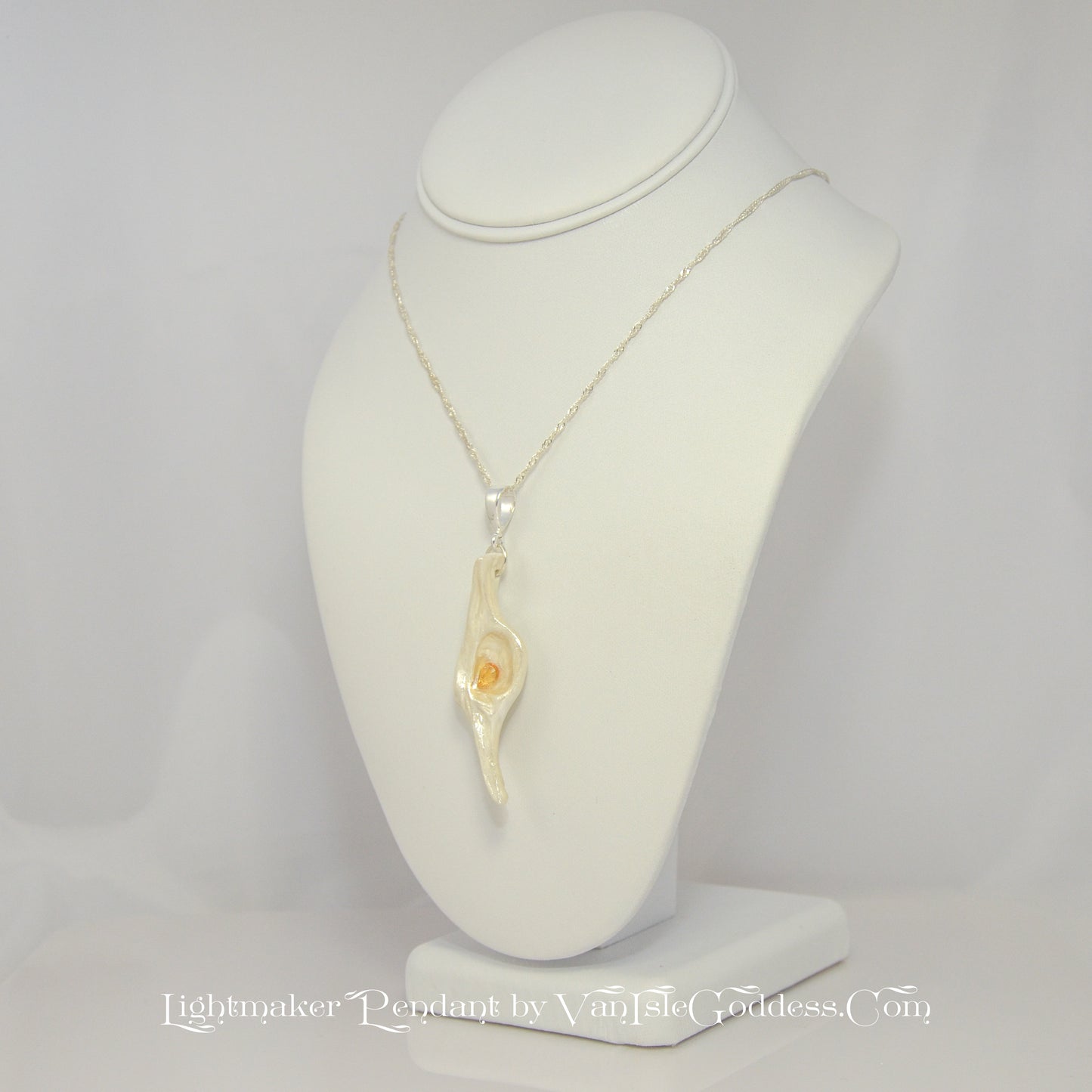 Lightmaker natural seashell pendant A beautiful pear shaped rose cut Citrine compliments the pendant. The pendant is turned to show the viewer the left side of the pendant.